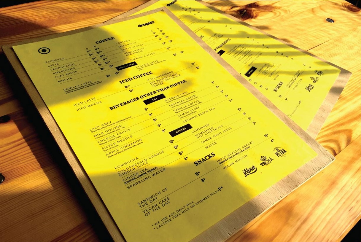 Photo of Dropin29's menu on a wooden table — placeholder, replace with Figma export