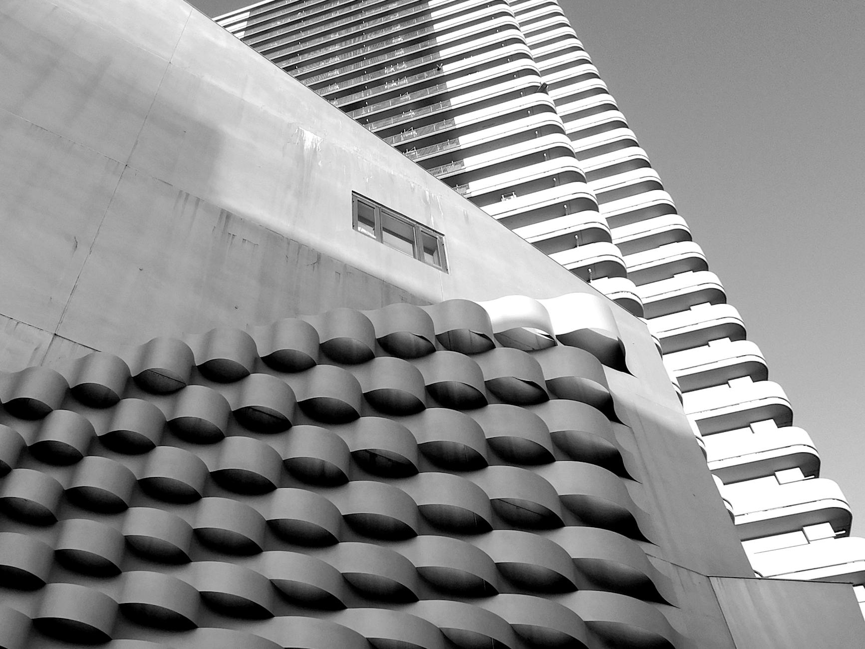 Abstract black and white photo of a modern high-rise building with unique architecture in Japan.