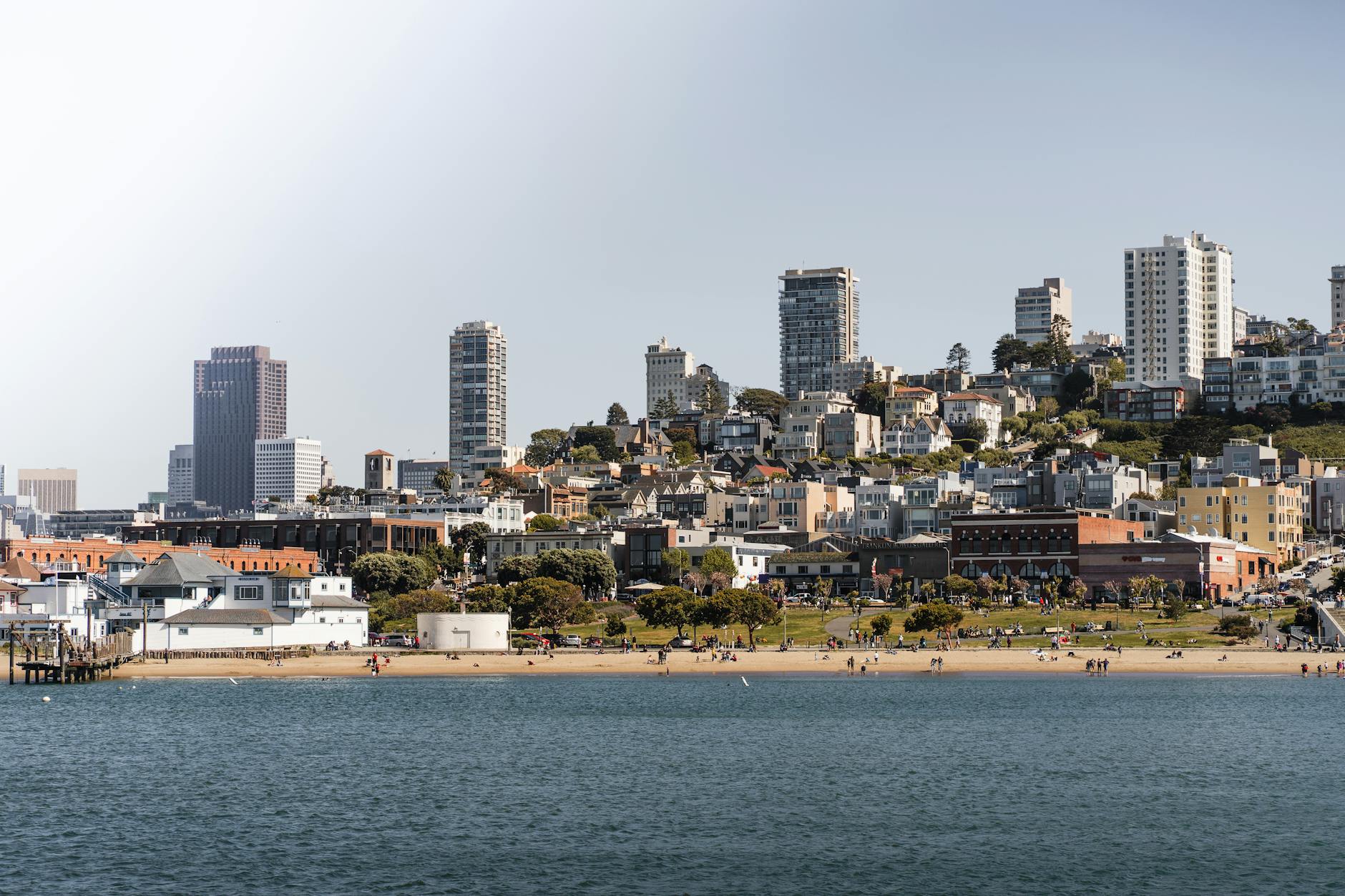 A scenic view of San Francisco's coastal skyline with beachfront and urban landscape.