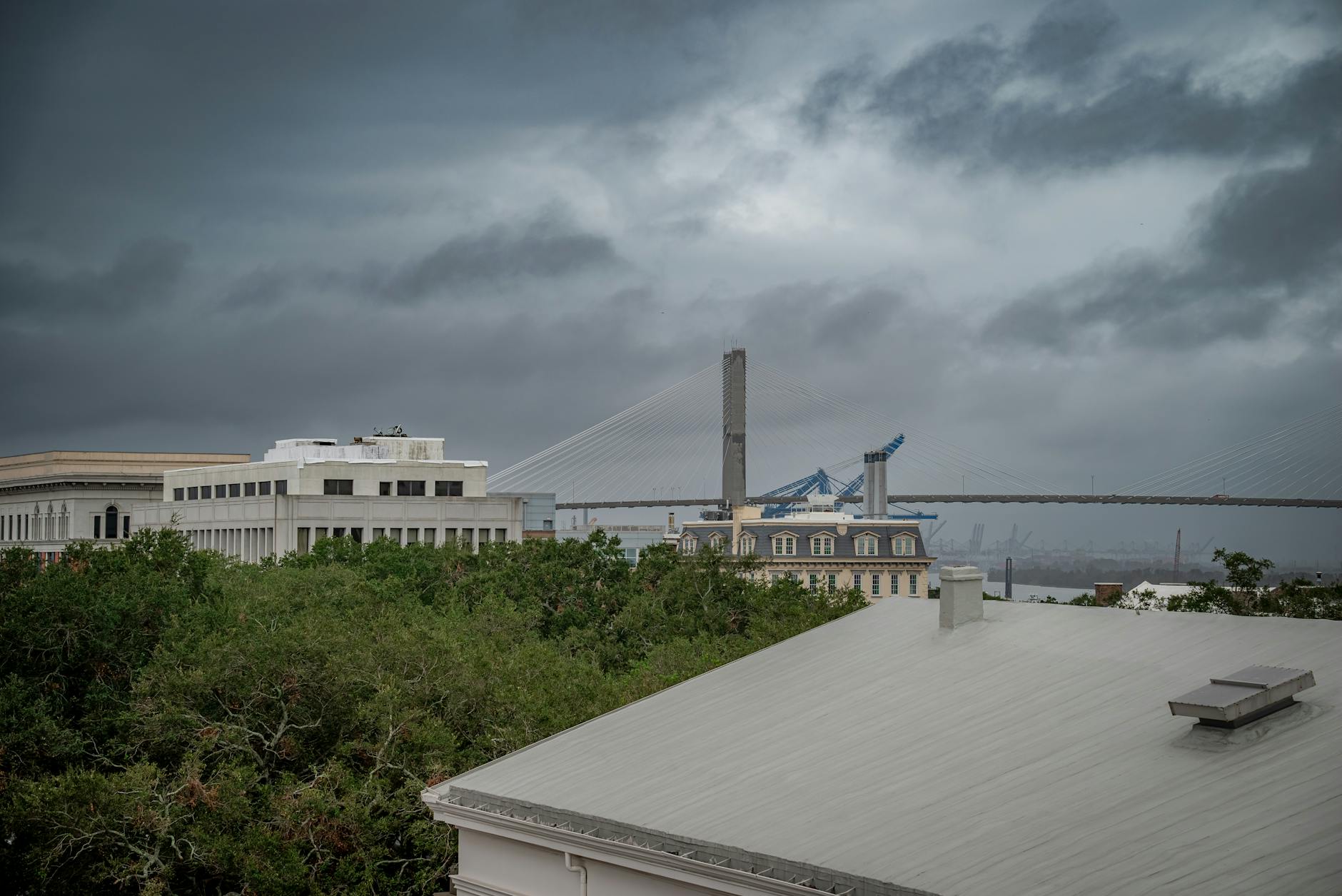 A stormy view of the Talmadge Bridge in Savannah, Georgia, showcasing dramatic clouds and architectural contrast.