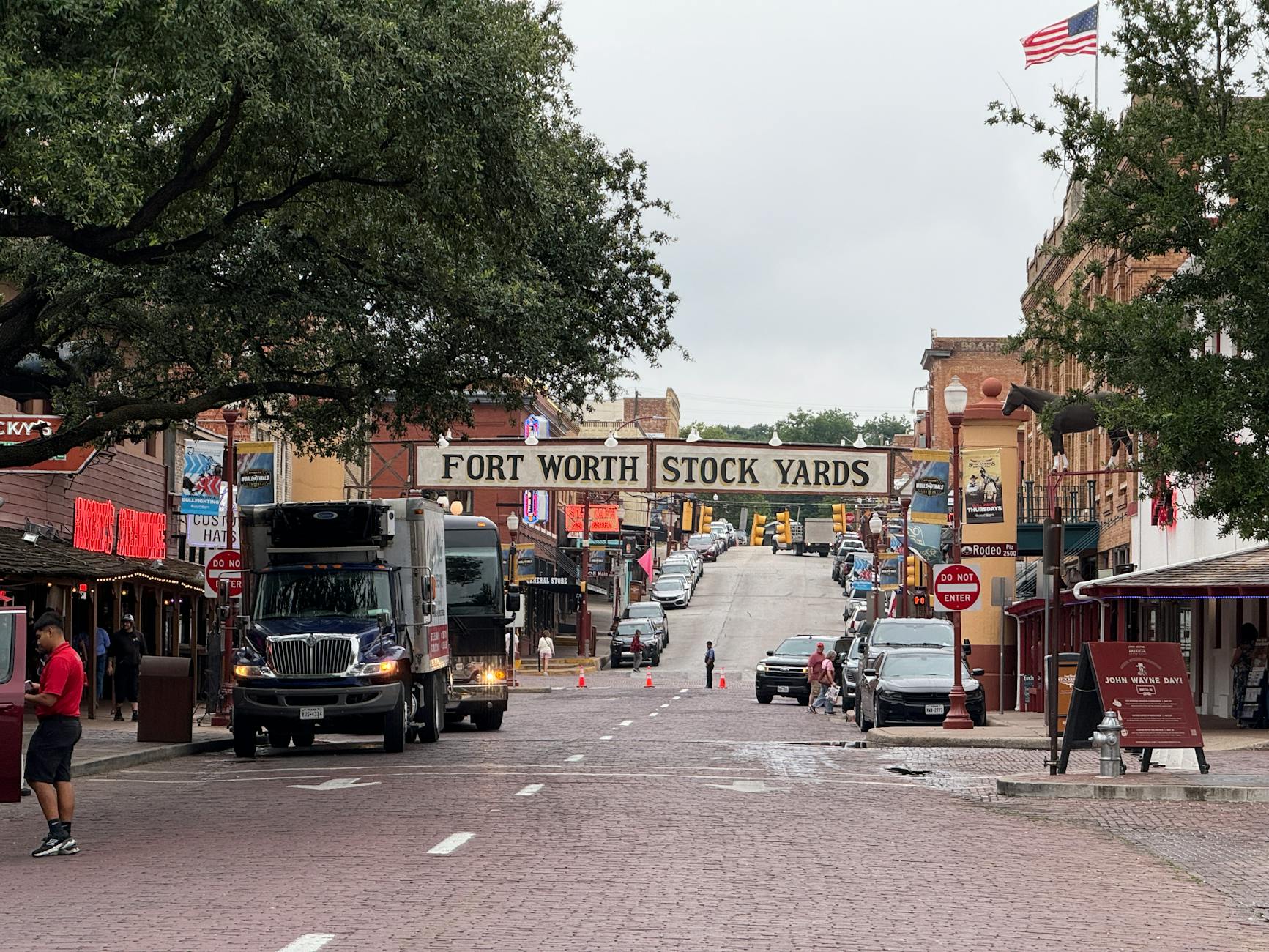 View of the historic Fort Worth Stockyards with bustling street and classic architecture in Texas.