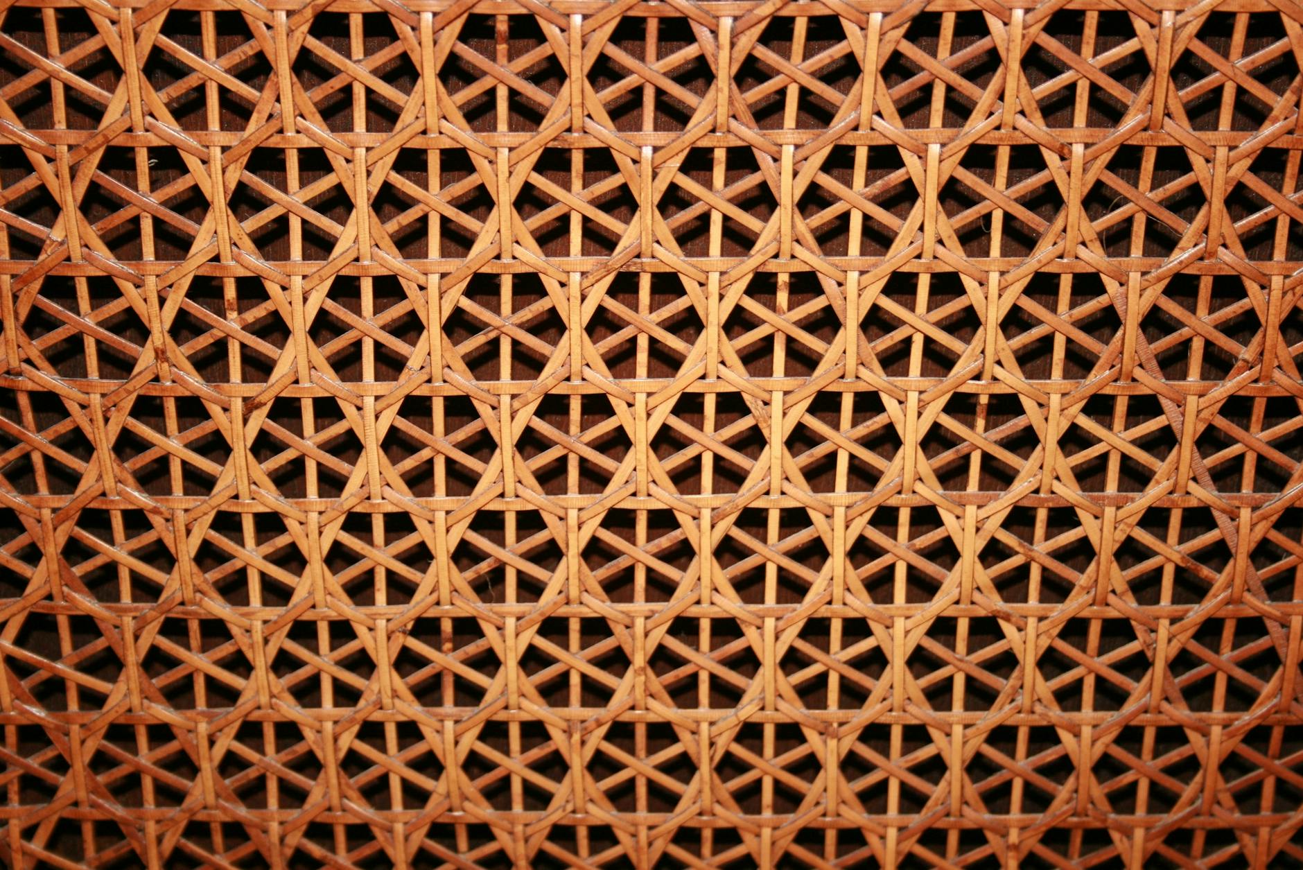 Close-up of a woven cane pattern showcasing intricate geometric design and natural texture.