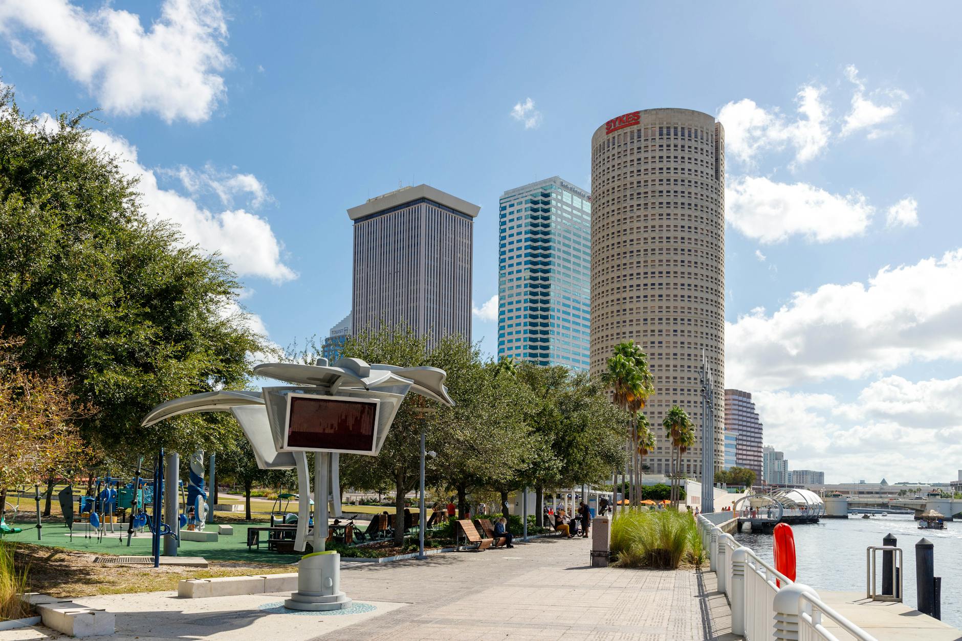 Explore the scenic Tampa Riverwalk with modern skyscrapers and lush parks.