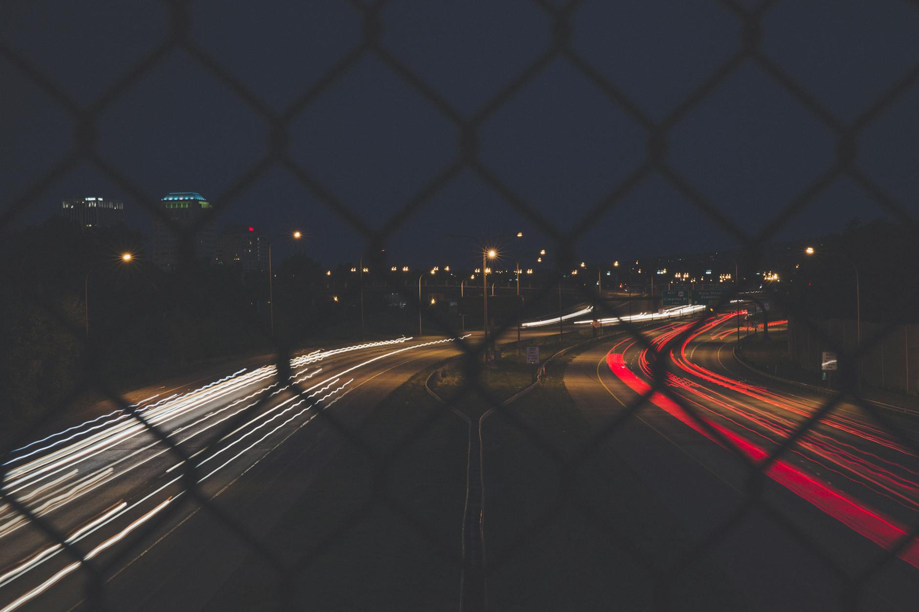 Dynamic night shot of flowing traffic under a starry sky in Colorado Springs.