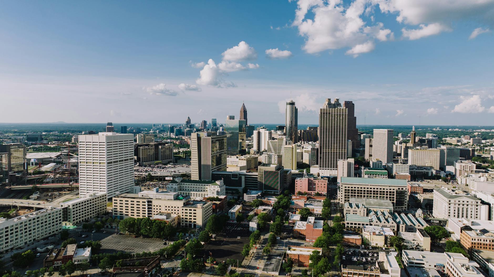 Stunning aerial view of Atlanta's modern skyline under a clear blue sky.
