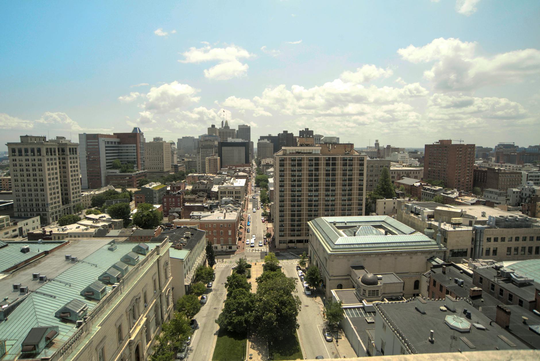 Aerial view of downtown Baltimore cityscape with historic architecture and skyline under clear skies.