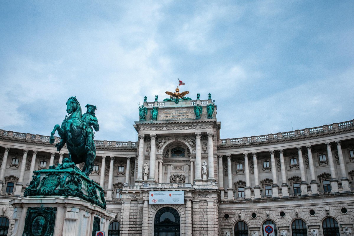 Majestic equestrian statue and Hofburg Palace in Vienna, showcasing classic architecture and cultural heritage.