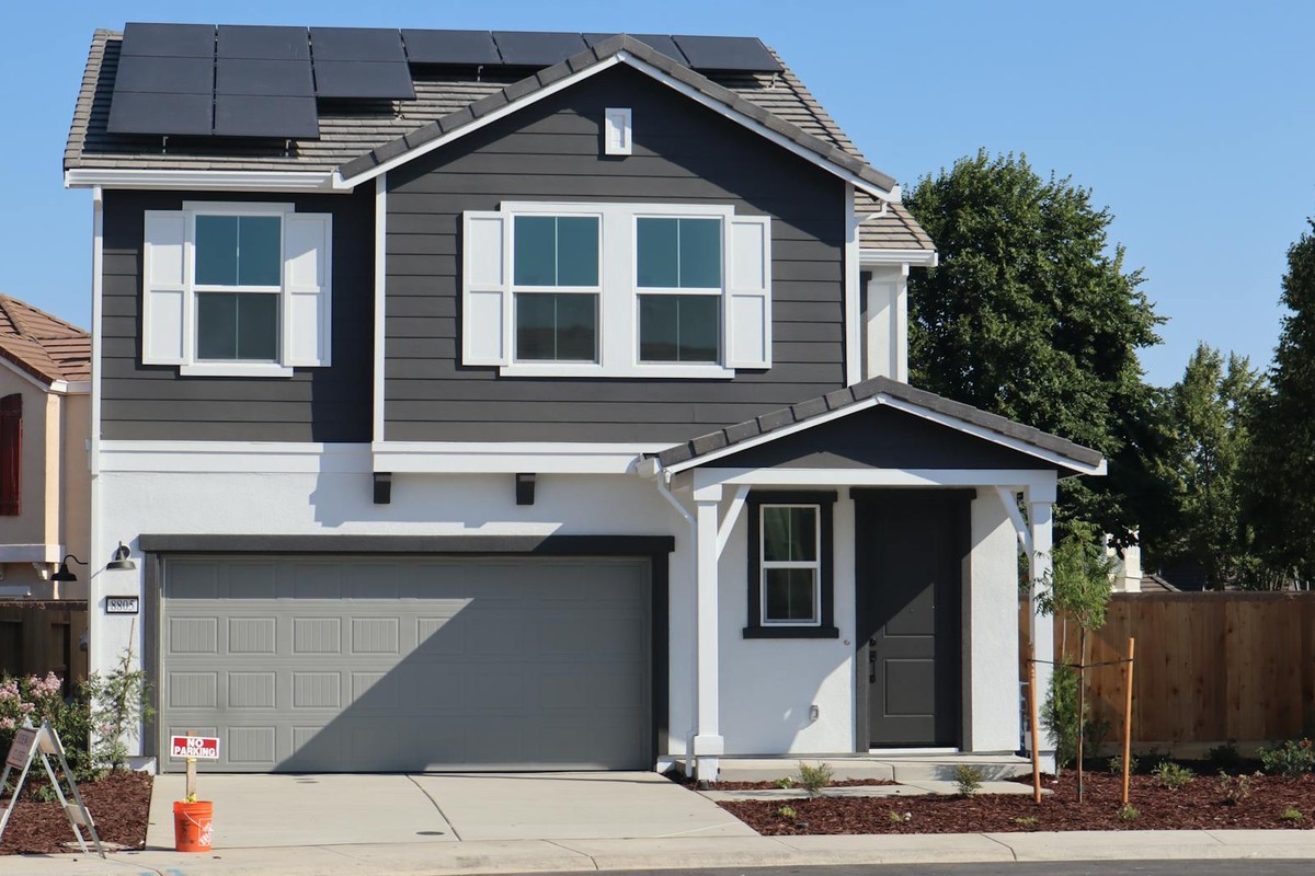 Newly constructed suburban home in Elk Grove, California, featuring solar panels and a stylish exterior.