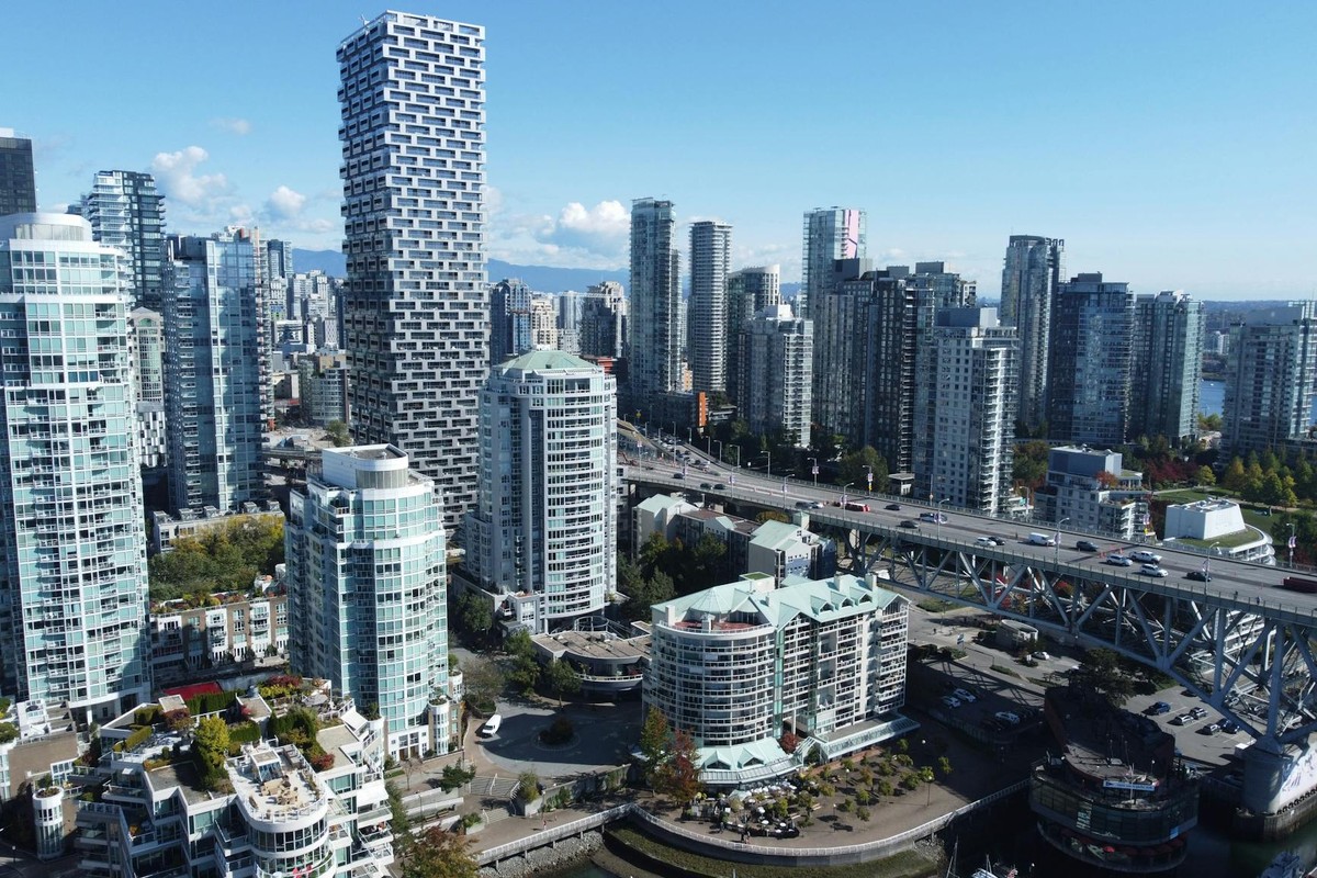 A stunning aerial view of Vancouver's skyline during daytime, showcasing modern architecture and bustling city life.