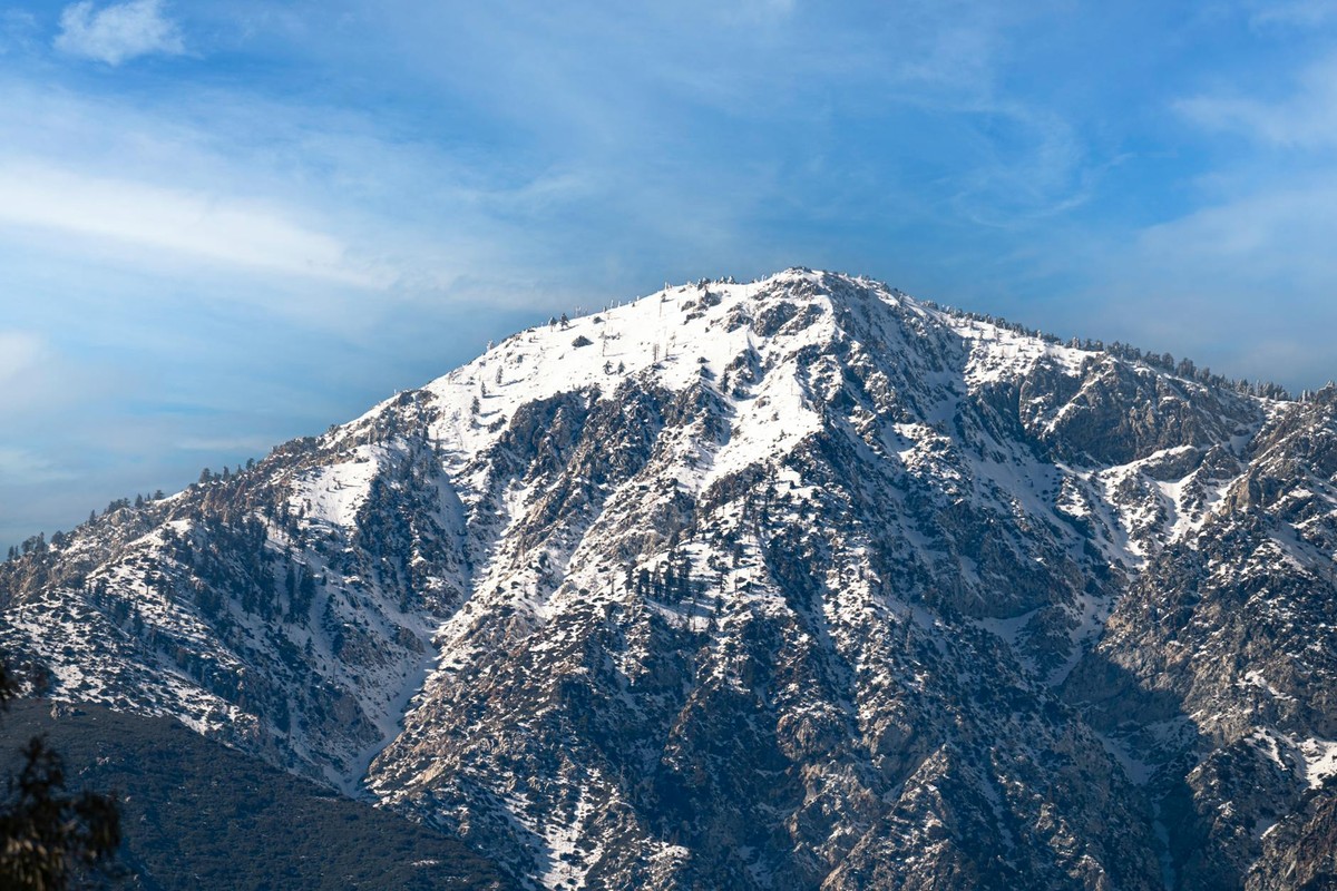 Majestic view of the snowcapped San Gabriel Mountains under a clear blue sky in winter.