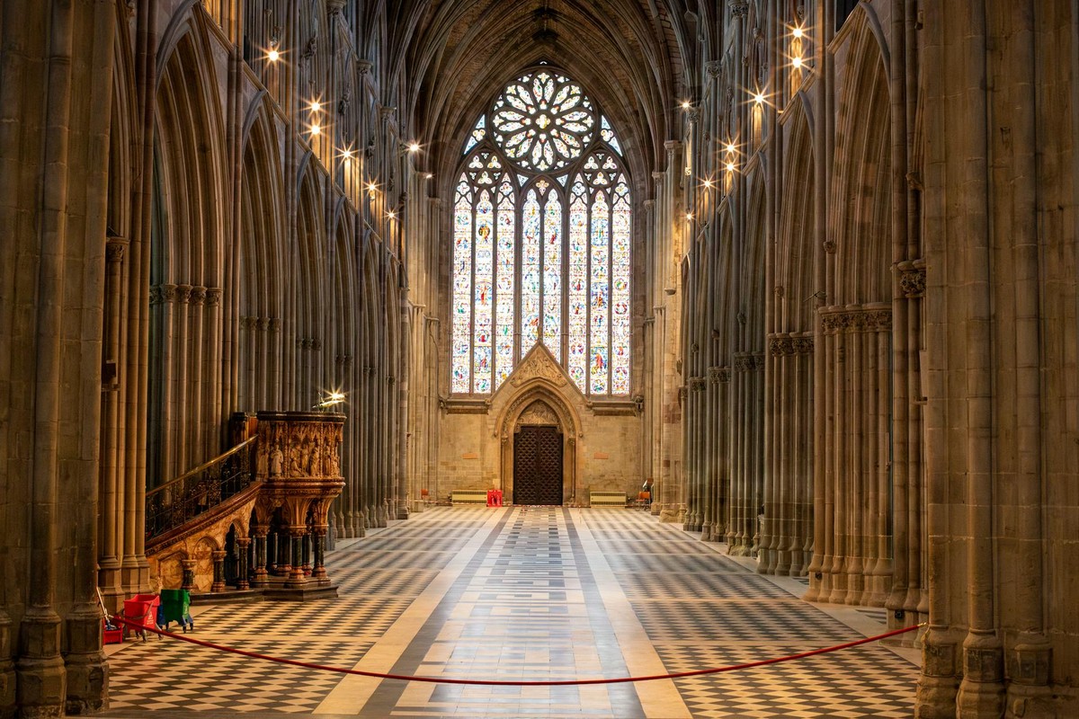 Explore the magnificent interior view of Worcester Cathedral with its towering arches and stained glass windows.
