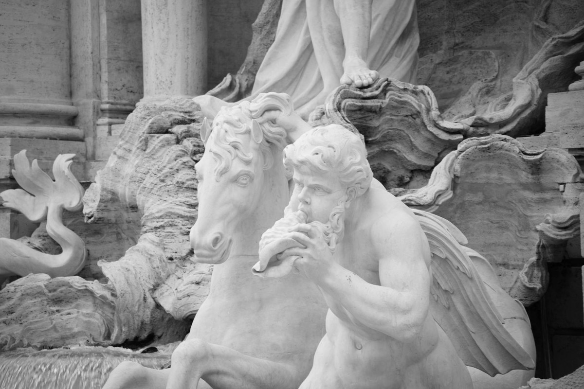 Close-up black and white photo of Fontana dei Quattro Fiumi in Rome, Italy, highlighting intricate sculptures.