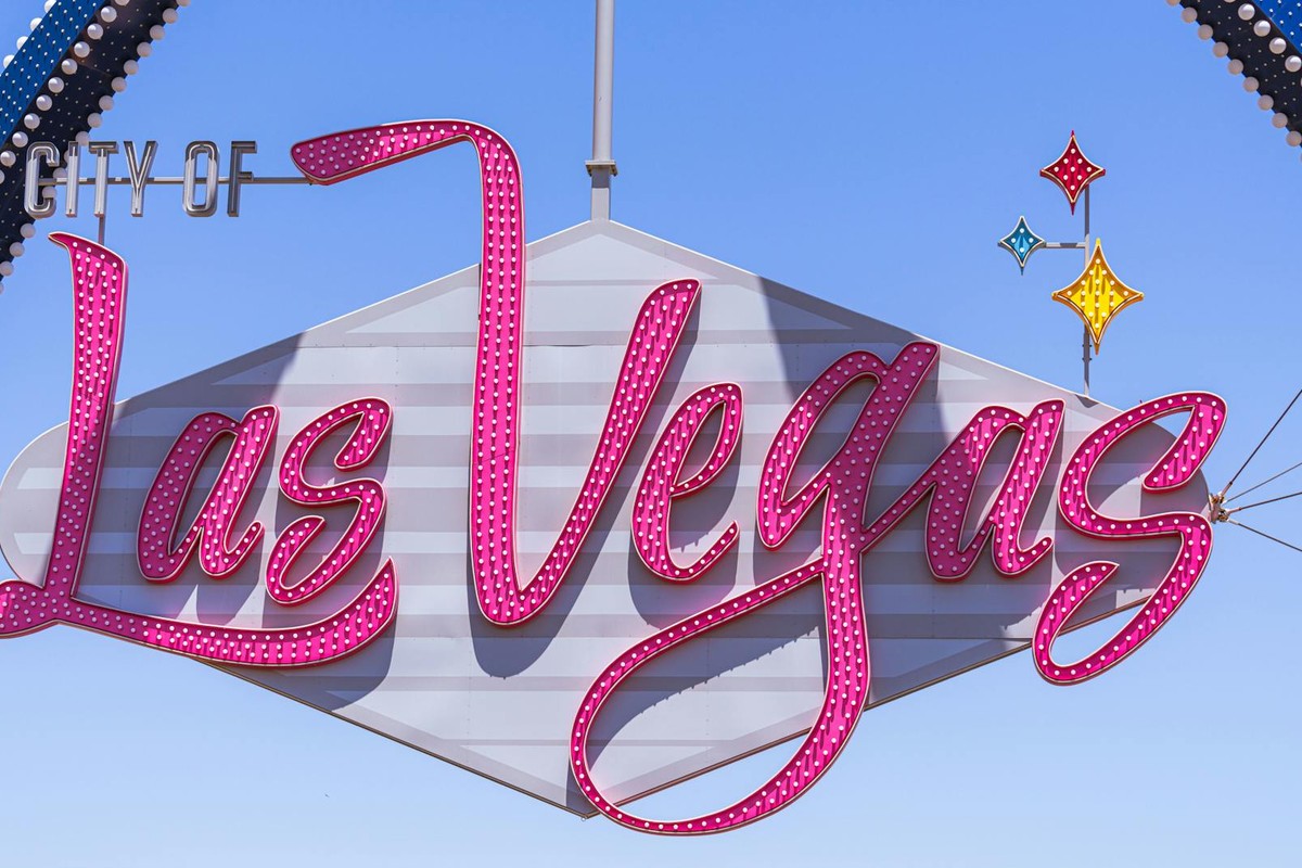 The famous Las Vegas sign with vibrant colors against a clear sky, a must-see landmark.