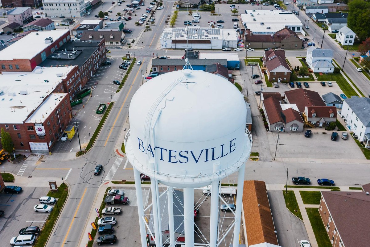 From above of white tall contemporary water tower surrounded by roads and buildings