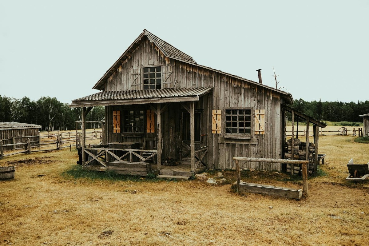 Charming rustic wooden house on a farm in rural Quebec, capturing country charm.