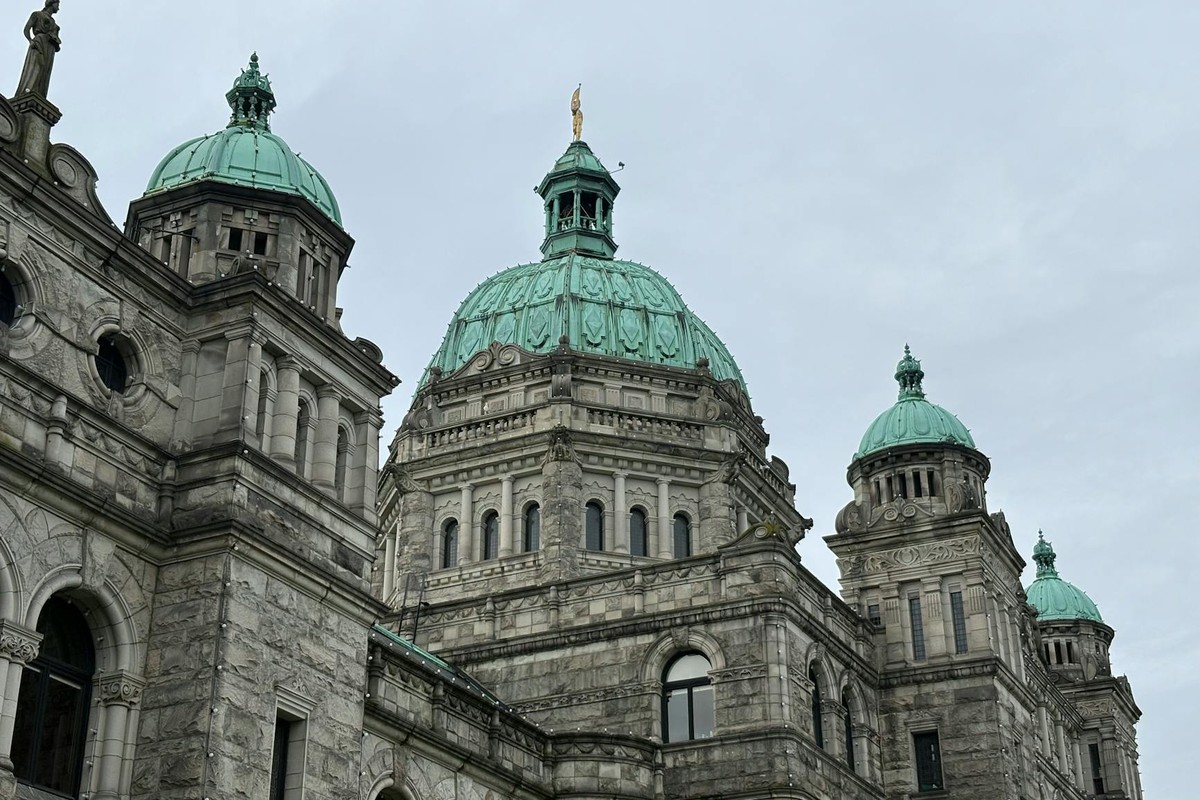 A close-up view of the historic Parliament Building in Victoria, British Columbia with its iconic green domes.