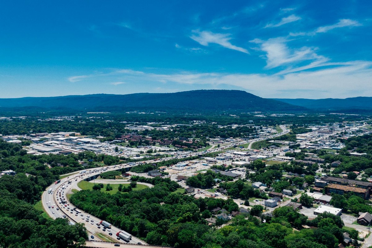 A stunning aerial view of Chattanooga, Tennessee, capturing the vibrant cityscape under a clear summer sky.