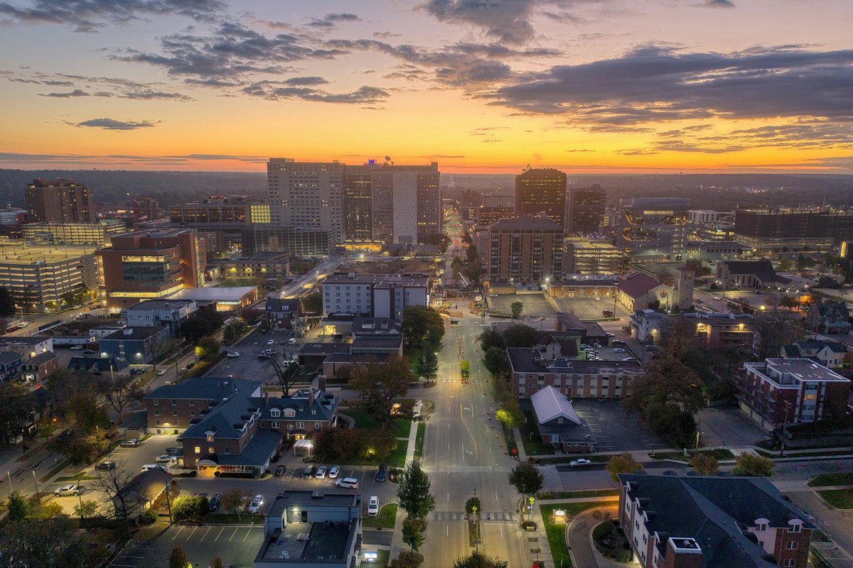 Breathtaking aerial view of Rochester, Minnesota's skyline at sunset, capturing urban lights and architecture.