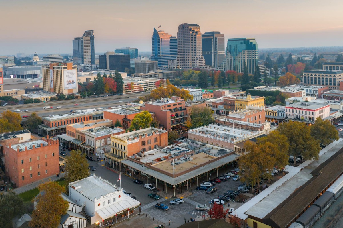 Stunning aerial view capturing the vibrant downtown Sacramento skyline with iconic buildings at sunset.