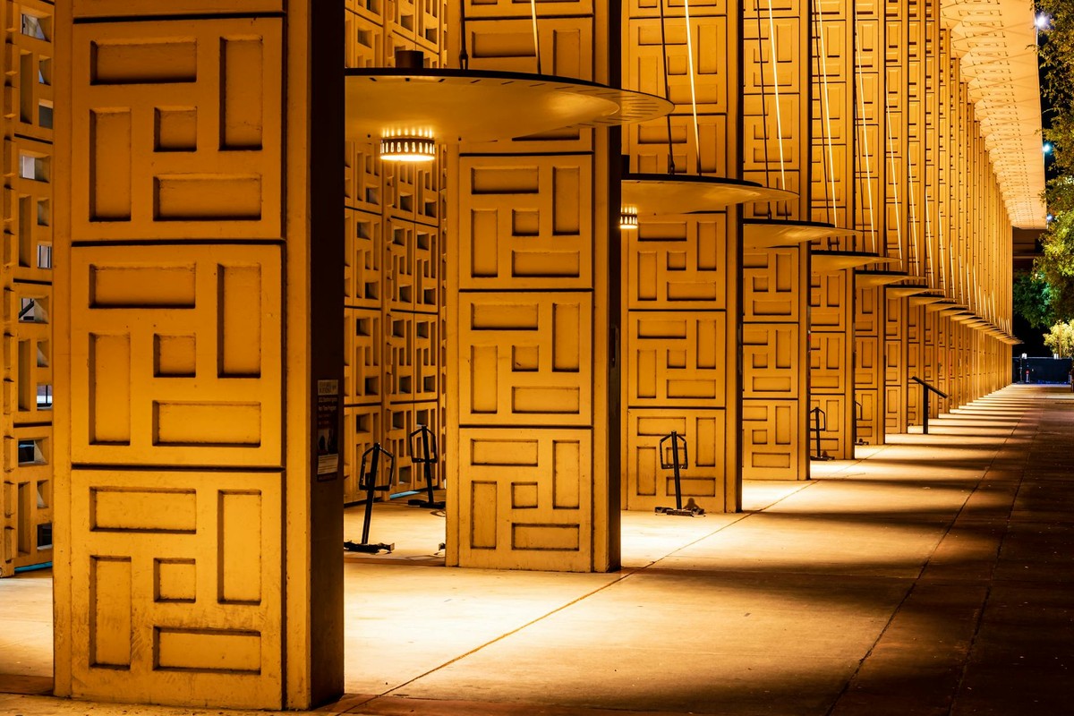 A striking view of an illuminated facade at Stanford University showcasing modern architecture.