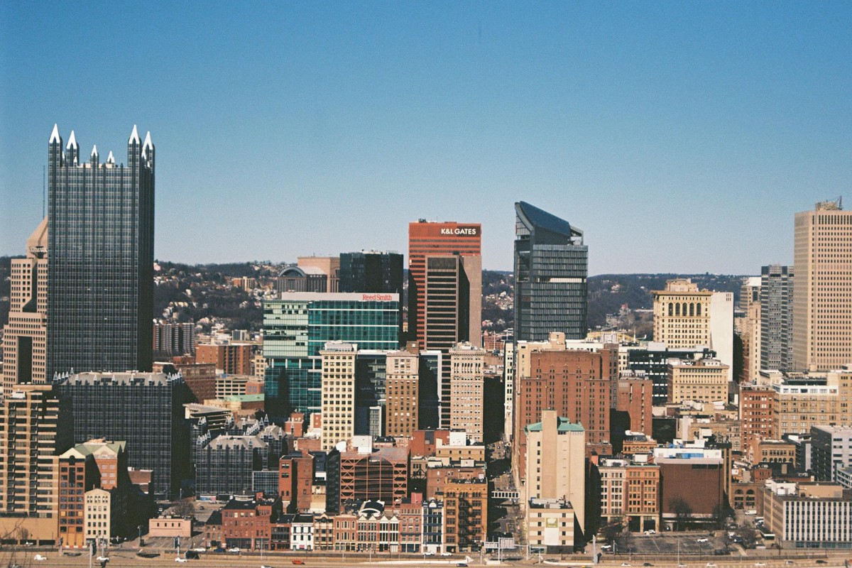 A crisp view of Pittsburgh's skyline with distinct skyscrapers against a clear blue sky.
