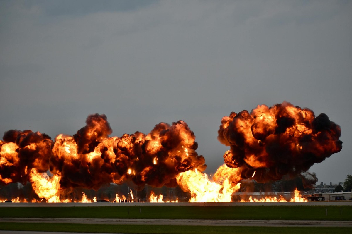 Dramatic explosion during airshow in Oshkosh, Wisconsin showcasing flames and smoke.