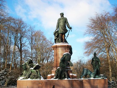 Snow-covered Bismarck Memorial in Berlin against a clear winter sky.