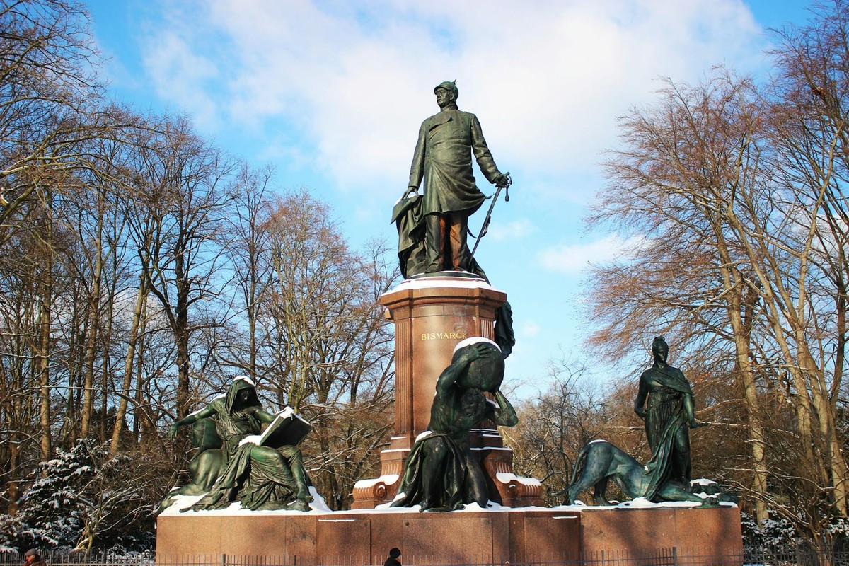 Snow-covered Bismarck Memorial in Berlin against a clear winter sky.