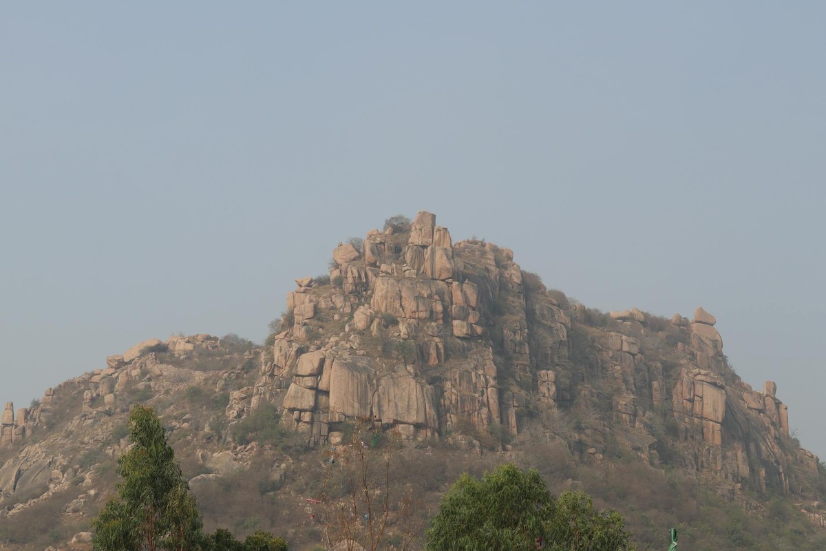 A stunning view of a rocky hill with clear skies, showcasing nature's beauty and rugged terrain.