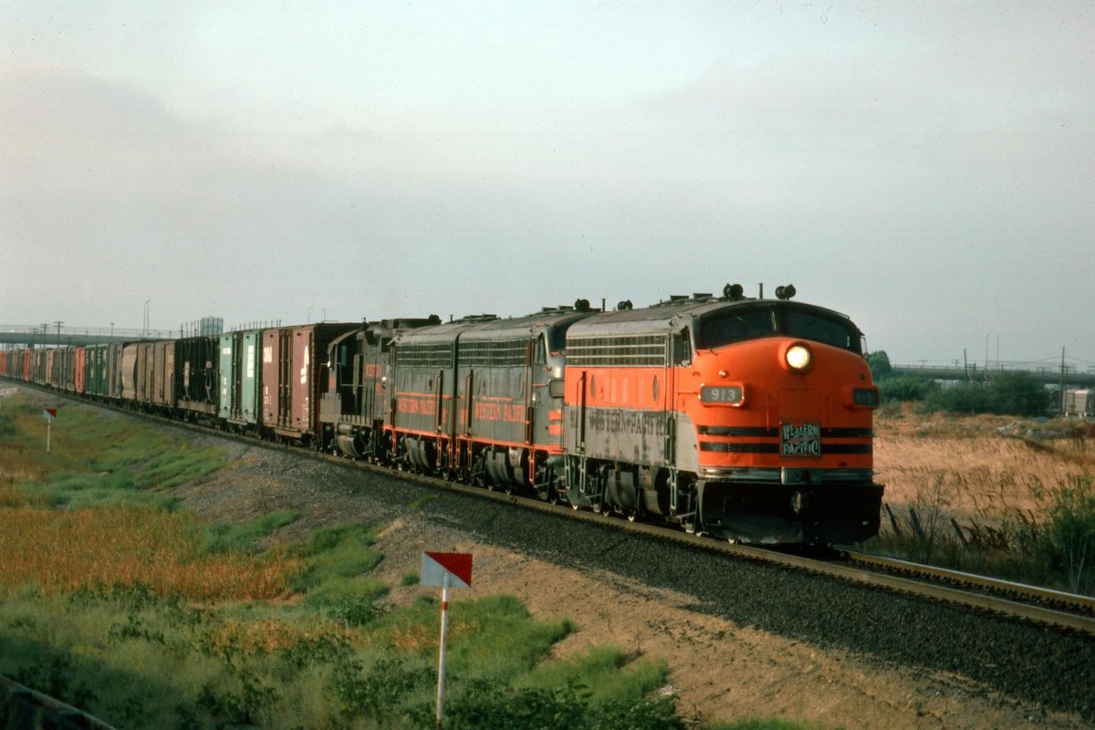A vintage diesel locomotive freight train traveling through Milpitas countryside.