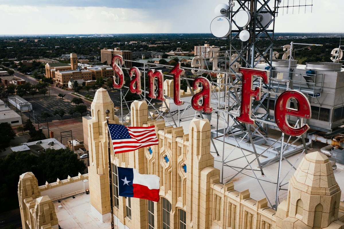 Aerial view of Santa Fe building rooftop with American and Texas flags in Amarillo, Texas.