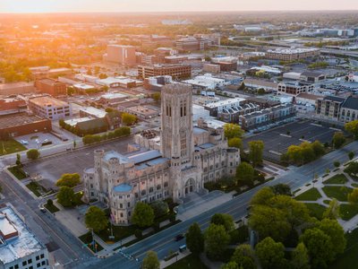 Aerial view of a historic building in downtown Indianapolis at sunset, showcasing urban architecture.