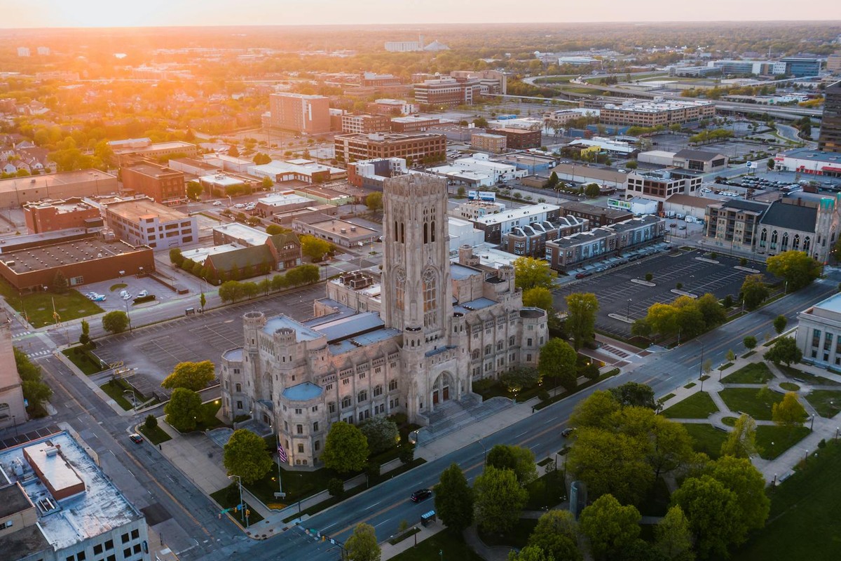 Aerial view of a historic building in downtown Indianapolis at sunset, showcasing urban architecture.