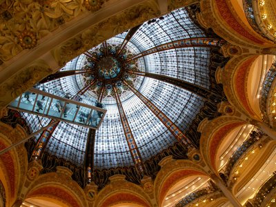 Explore the stunning dome interior of Galeries Lafayette in Paris showcasing intricate architecture.
