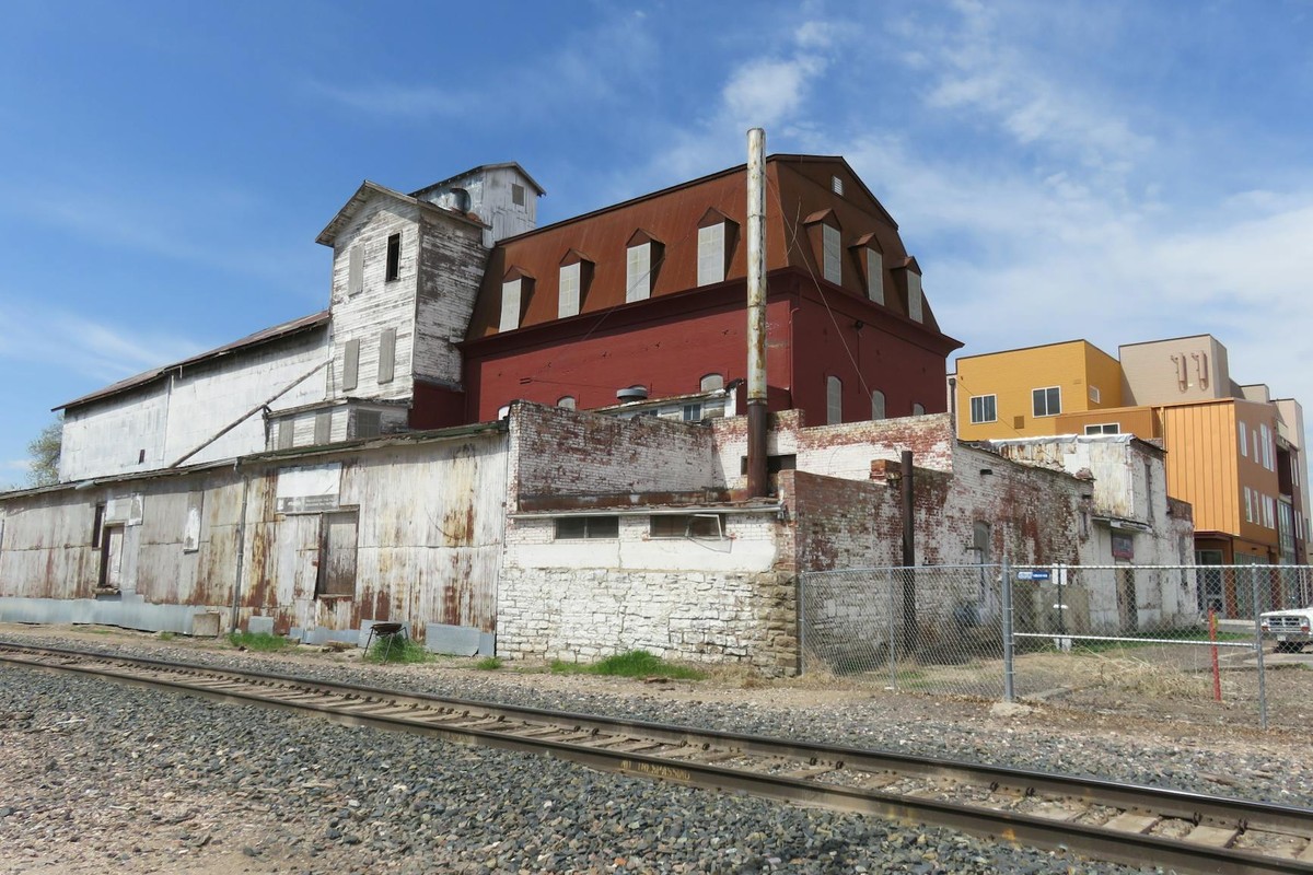 Explore rustic industrial buildings along the train tracks in Loveland, Colorado.