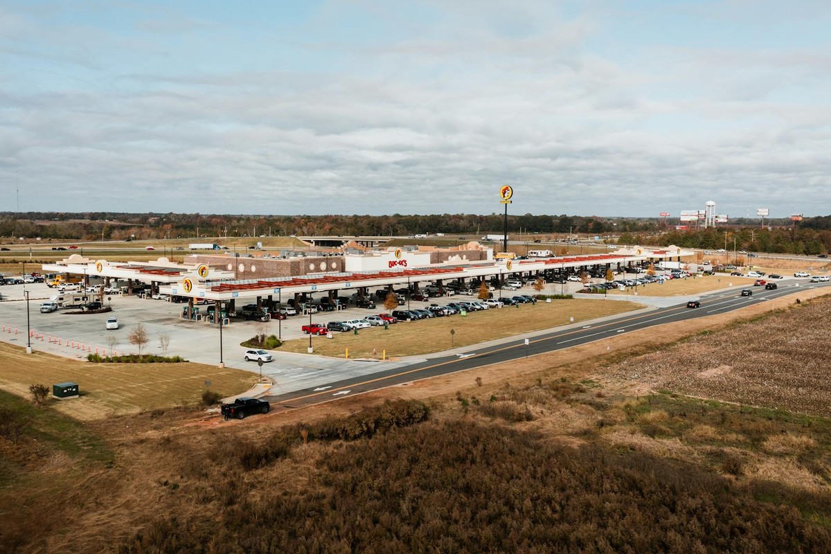 Wide aerial view of Buc-ee's gas station in Warner Robins, Georgia surrounded by lush landscape.