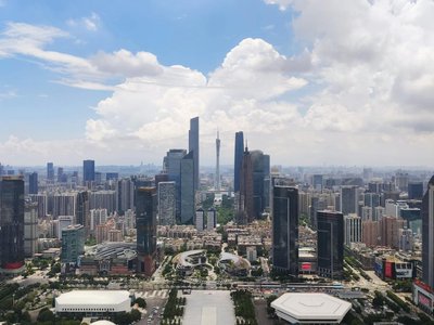 A stunning aerial view of Guangzhou's cityscape and skyscrapers under a blue sky.