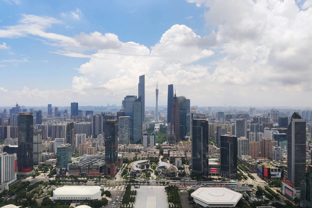 A stunning aerial view of Guangzhou's cityscape and skyscrapers under a blue sky.