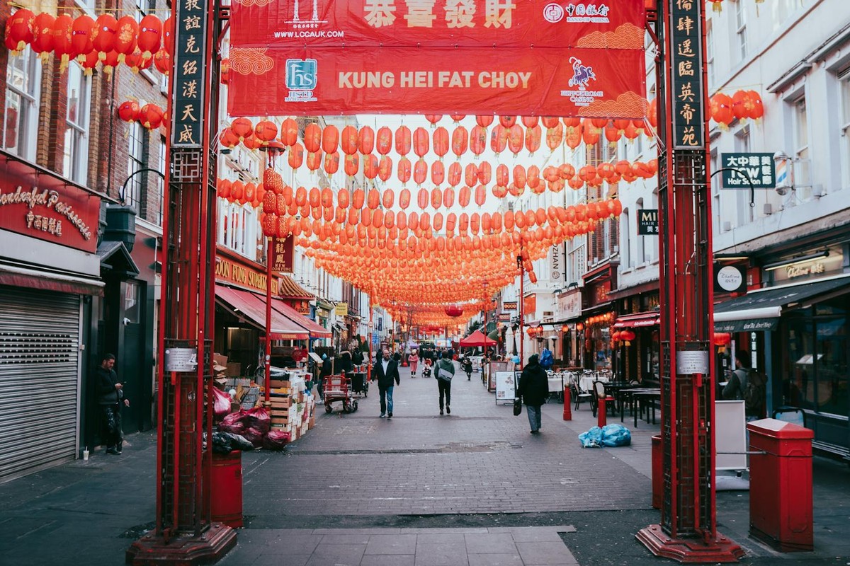 Vibrant street in London's Chinatown adorned with red lanterns, capturing cultural essence.