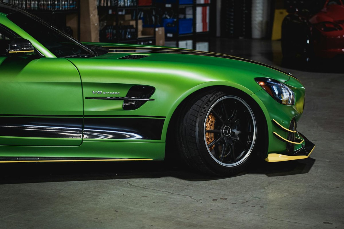 Explore a luxury green Mercedes-AMG GT in an urban garage setting, captured with a modern touch.