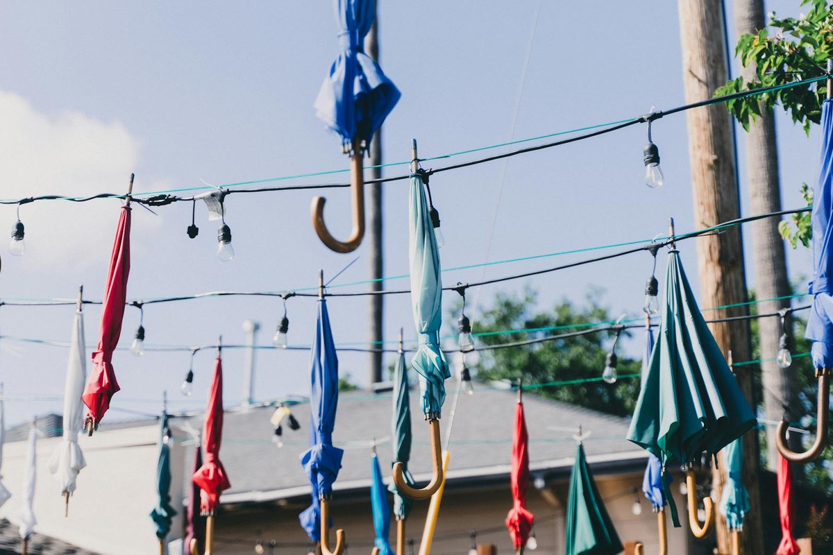 Vibrant umbrellas suspended with string lights outdoors in Pleasanton, California.