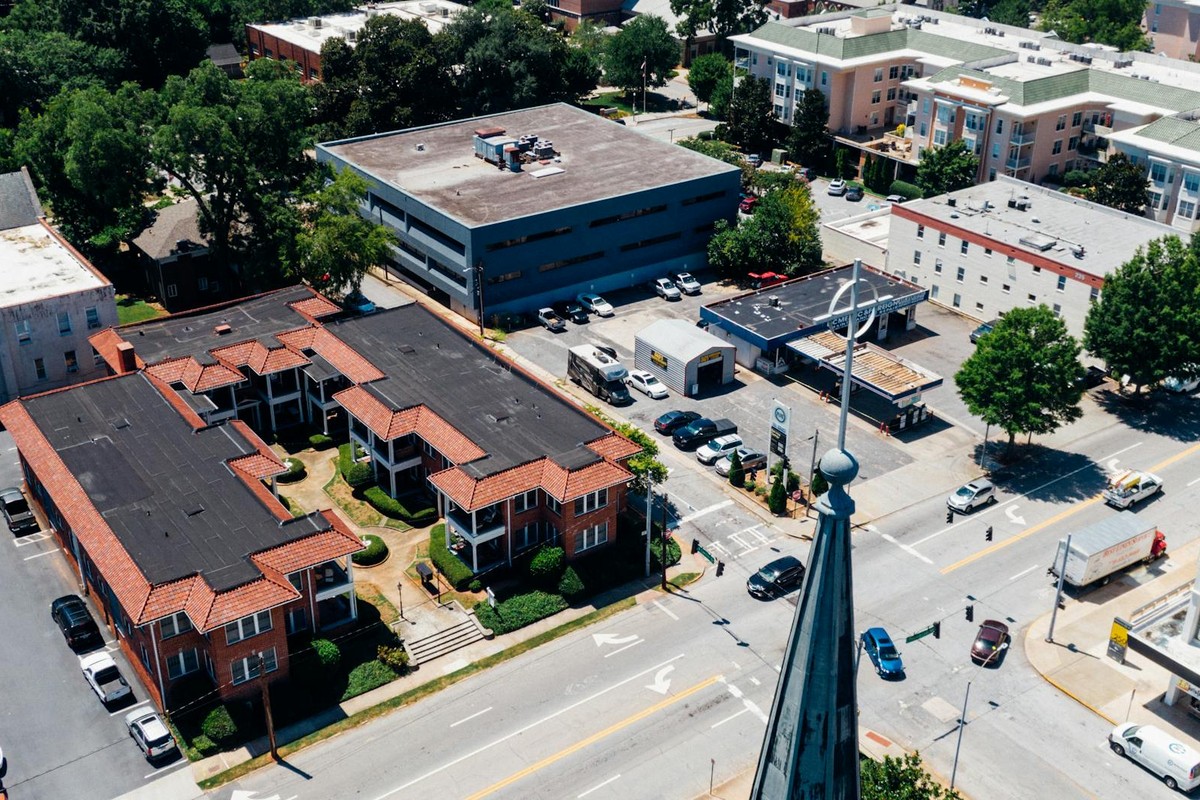 Aerial view of Decatur cityscape showing streets, buildings, and vehicles on a sunny day.