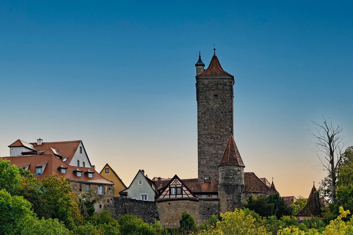 Charming view of Rothenburg ob der Tauber's medieval architecture against a twilight sky.
