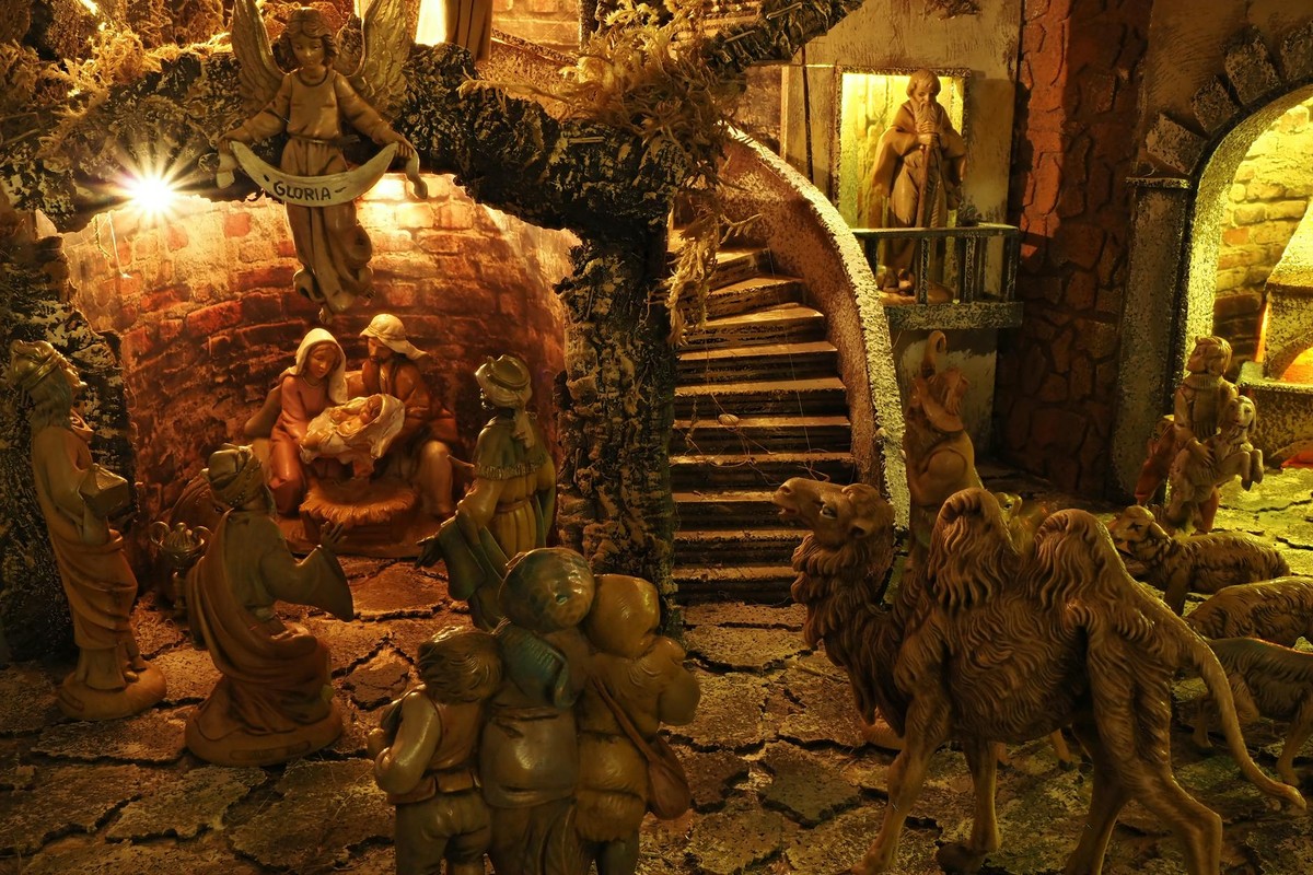 Detailed nativity scene showcasing baby Jesus, Mary, Joseph, and biblical figures in warm lighting.