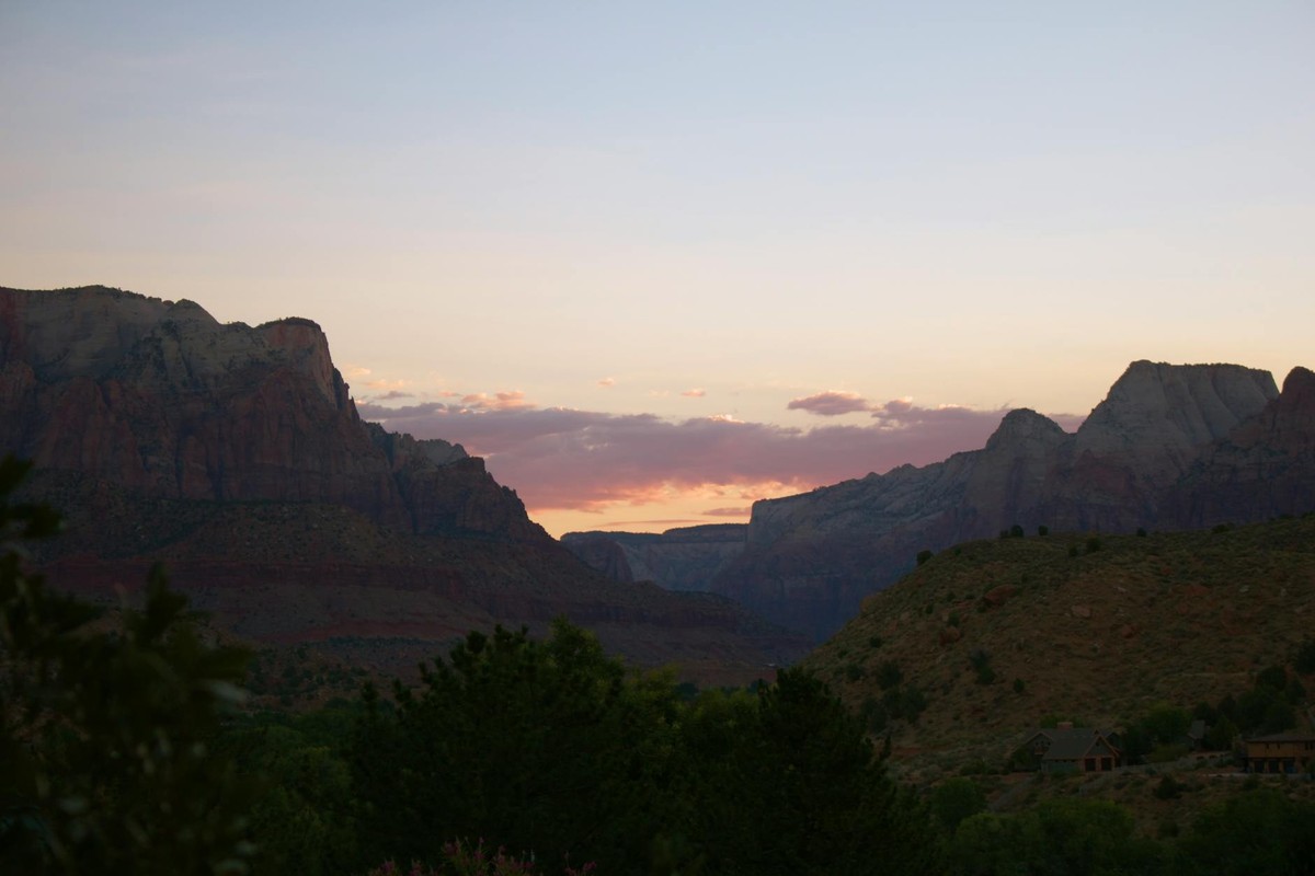 Beautiful sunset casting a warm glow over the cliffs in Zion National Park.