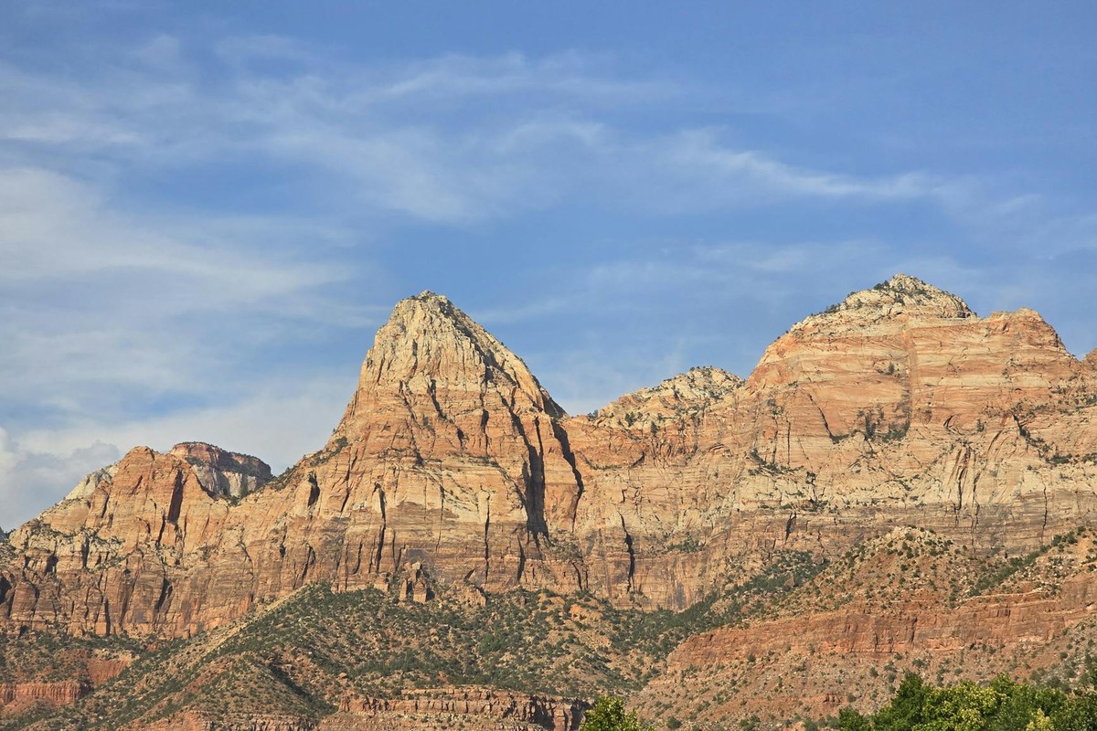 Stunning view of the sandstone cliffs in Zion National Park, Utah, under a clear blue sky.