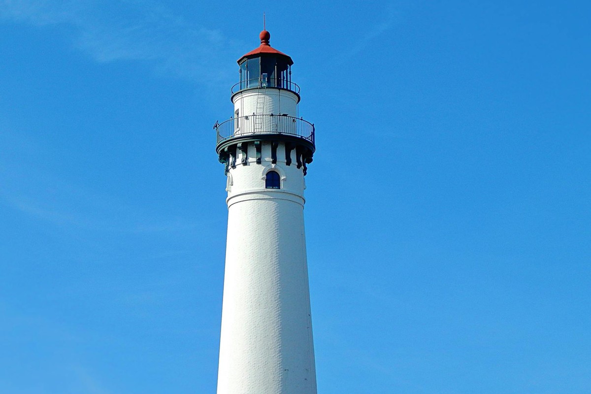 View of Wind Point Lighthouse in front of a clear blue sky in Wisconsin.