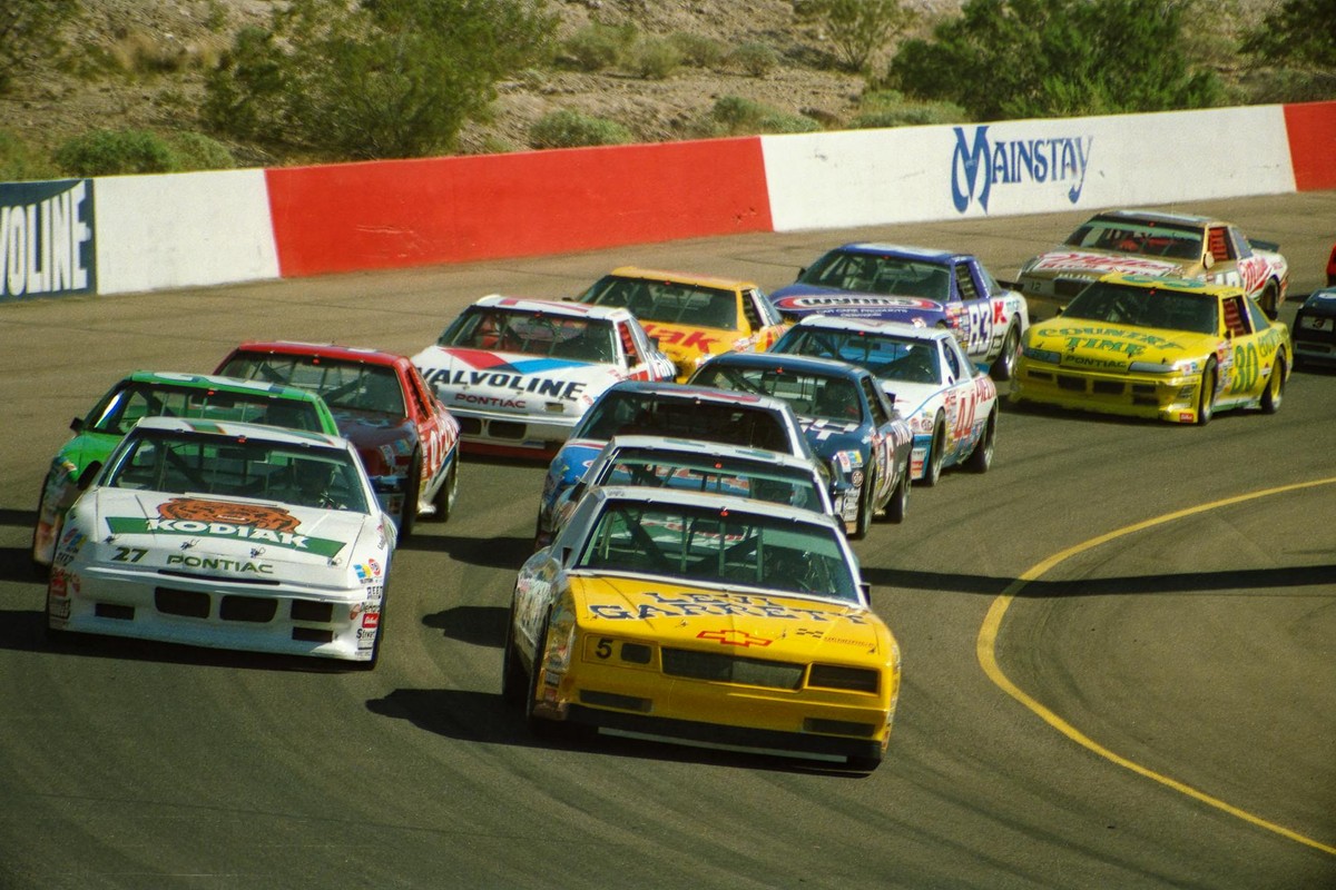 Exciting NASCAR race at Phoenix Raceway in Avondale, Arizona with colorful cars in action.