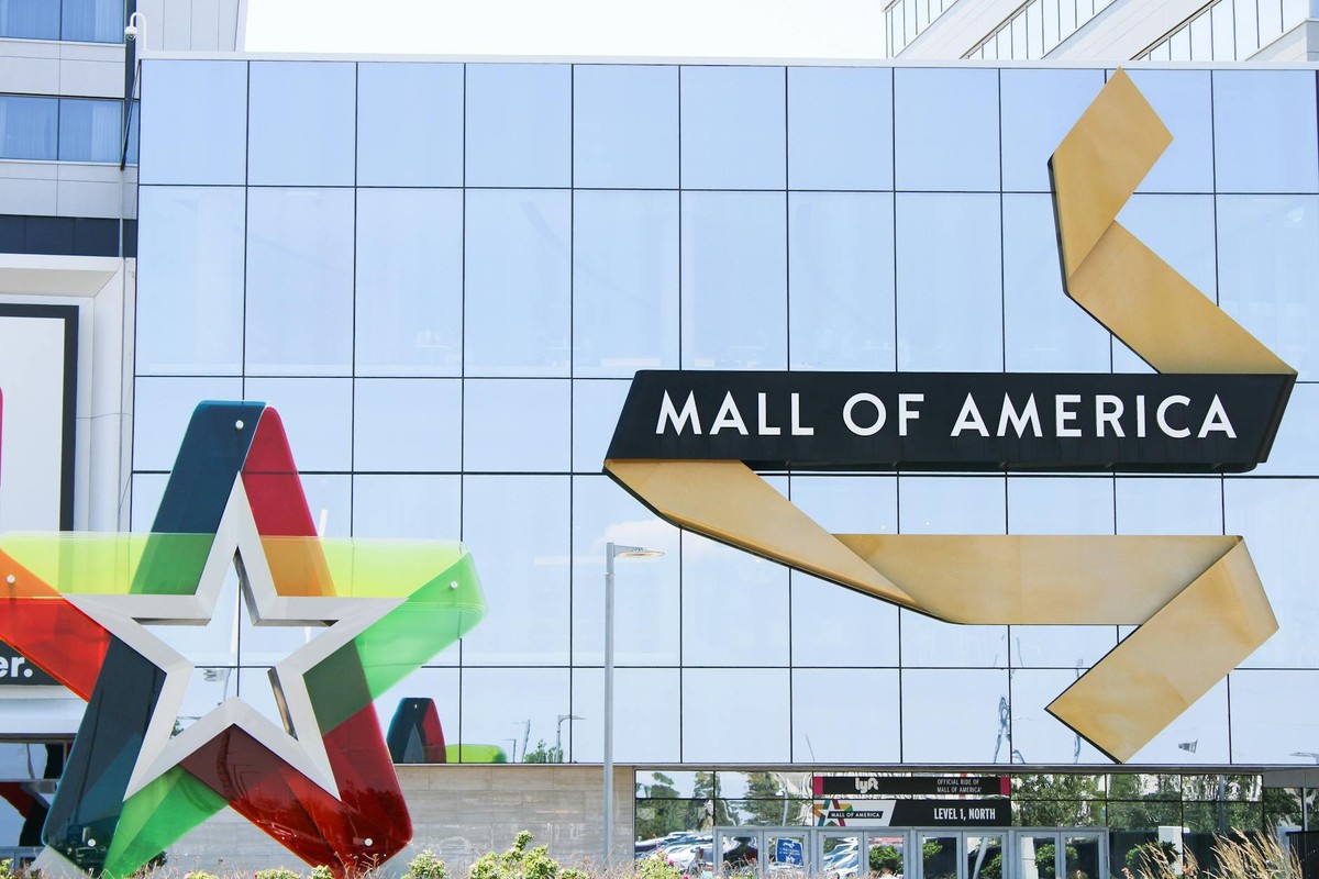 Exterior of Mall of America with glass facade and colorful star decoration in Bloomington, MN.