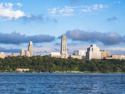 View of Riverside Church and New York skyline across the Hudson River on a sunny day.